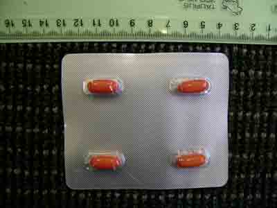 Unnamed orange capsules in plastic and silver foil blister with green print